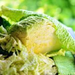 Verza fresca su un tagliere con coltello, pronta per una ricetta sana e gustosa.