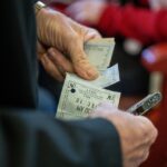 Uomo anziano sorride mentre riceve informazioni sull'esenzione del ticket sanitario.